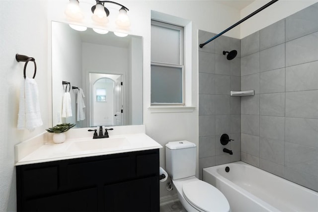 full bathroom featuring vanity, toilet, and tiled shower / bath combo