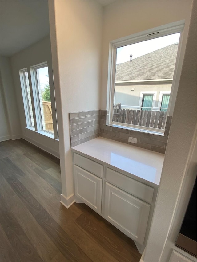 bathroom with backsplash and hardwood / wood-style floors