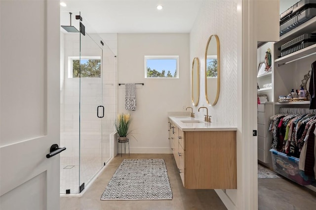 14701 Longbranch Dr, Austin, TX 78734 - bathroom featuring double vanity, concrete flooring, a shower stall, healthy amount of natural light, and recessed lighting