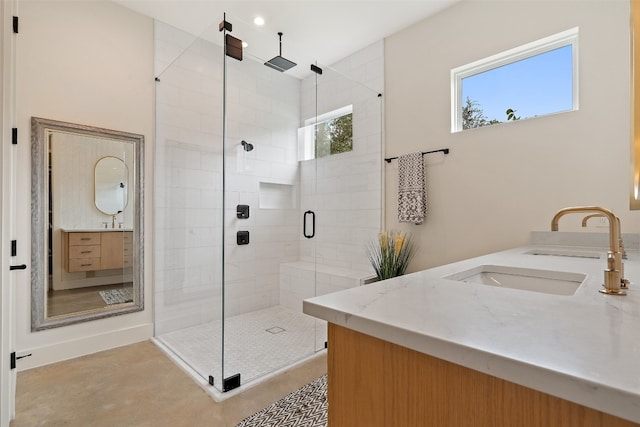 bathroom featuring walk in shower and vanity