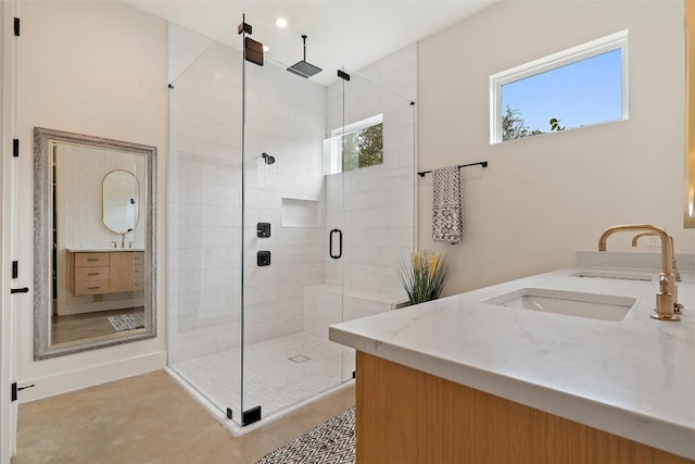 bathroom featuring vanity and a shower with door