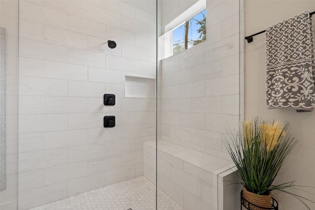 bathroom with a tile shower