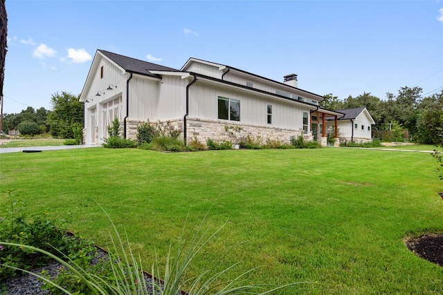 view of property exterior with a garage and a yard