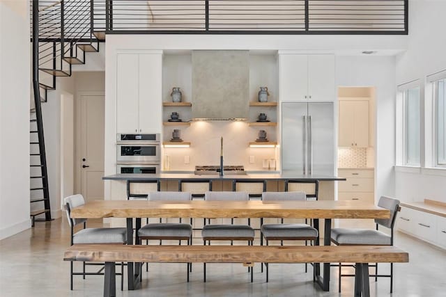 dining room featuring a towering ceiling