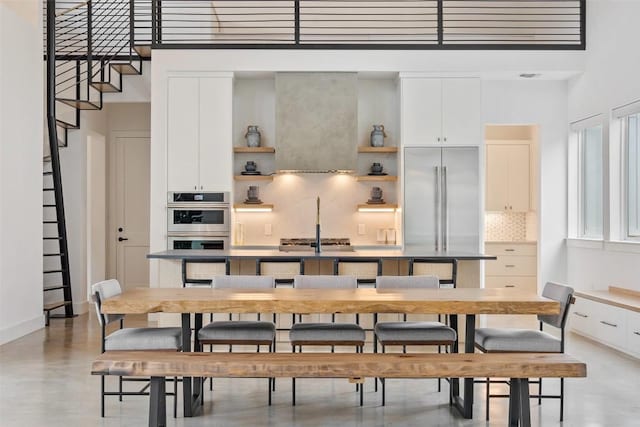 14701 Longbranch Dr, Austin, TX 78734 - dining space featuring a high ceiling and finished concrete floors
