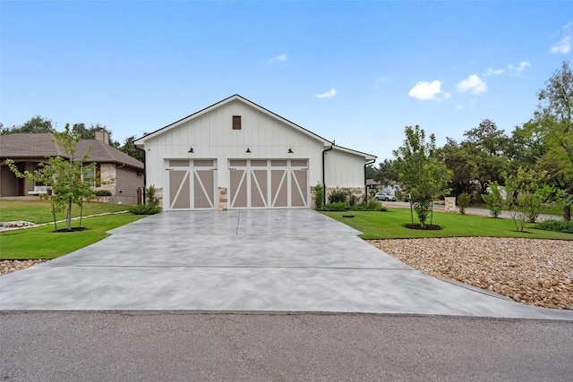 modern inspired farmhouse featuring a front lawn and a garage