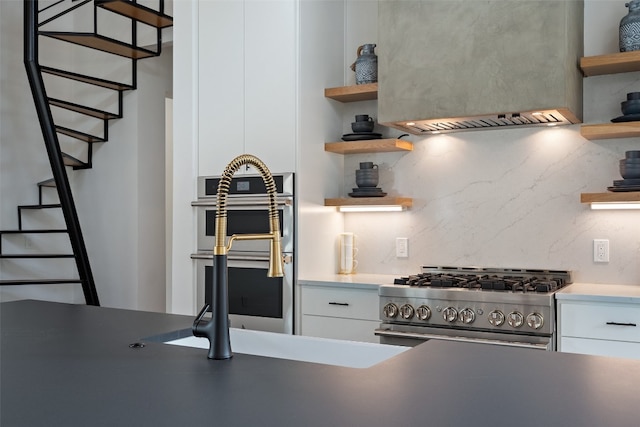 kitchen featuring white cabinetry, backsplash, and stainless steel appliances