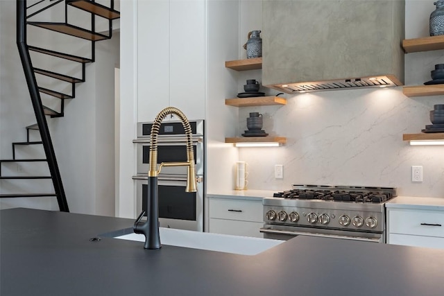 14701 Longbranch Dr, Austin, TX 78734 - kitchen featuring open shelves, appliances with stainless steel finishes, custom exhaust hood, and white cabinetry