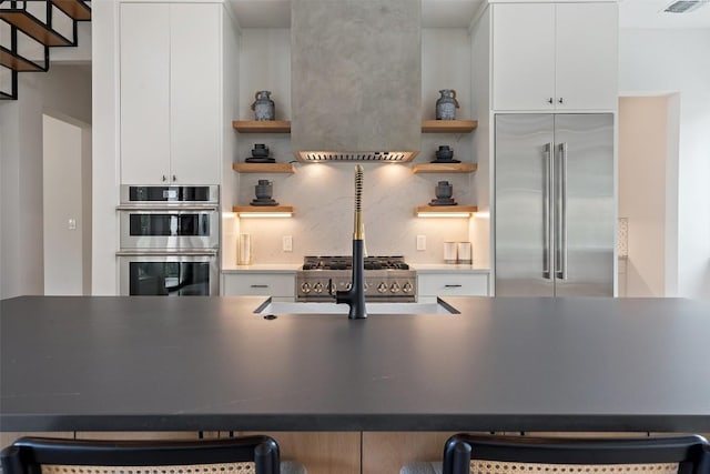 14701 Longbranch Dr, Austin, TX 78734 - kitchen with stainless steel appliances, open shelves, and white cabinets
