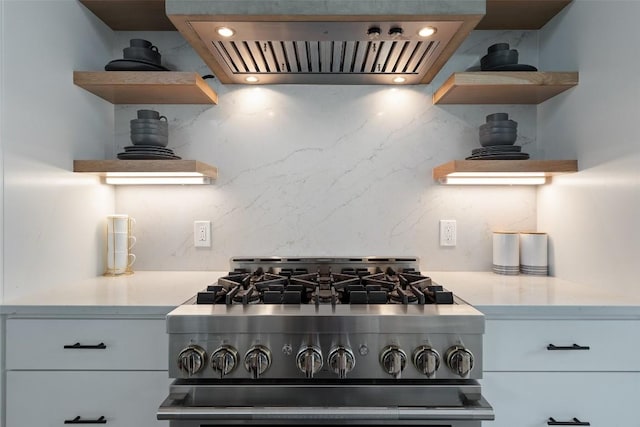 14701 Longbranch Dr, Austin, TX 78734 - kitchen featuring open shelves, stainless steel range with gas stovetop, ventilation hood, and decorative backsplash