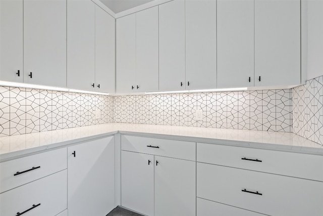 kitchen with white cabinets and decorative backsplash