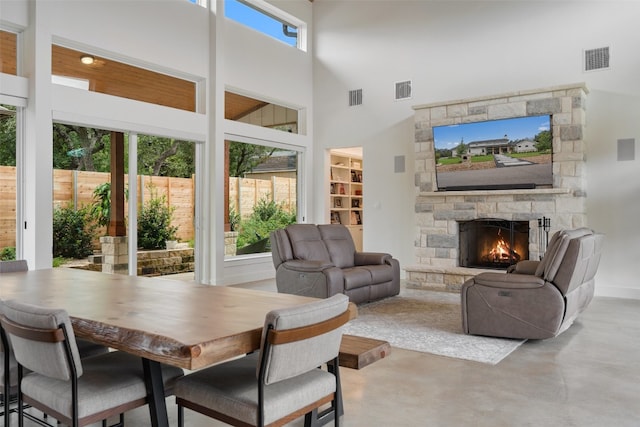 interior space featuring a fireplace, a healthy amount of sunlight, and concrete floors