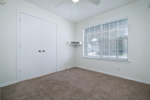 unfurnished bedroom featuring a closet, carpet flooring, and ceiling fan