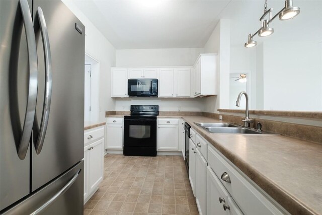 kitchen with a sink, white cabinets, black appliances, and light countertops