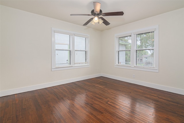 spare room featuring dark wood-type flooring and ceiling fan