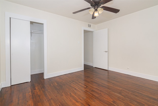 unfurnished bedroom with ceiling fan, dark hardwood / wood-style floors, and a closet