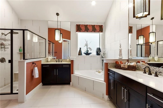 bathroom featuring vanity, tile patterned flooring, and shower with separate bathtub