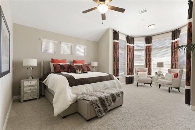 bedroom with light colored carpet, ceiling fan, and multiple windows