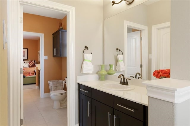 bathroom featuring tile patterned flooring, toilet, and vanity