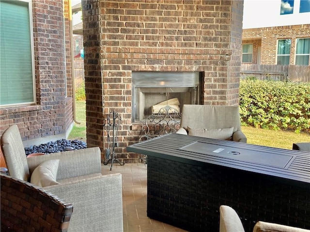 view of patio / terrace with an outdoor living space with a fireplace