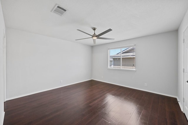 unfurnished room with ceiling fan, dark hardwood / wood-style flooring, and a textured ceiling