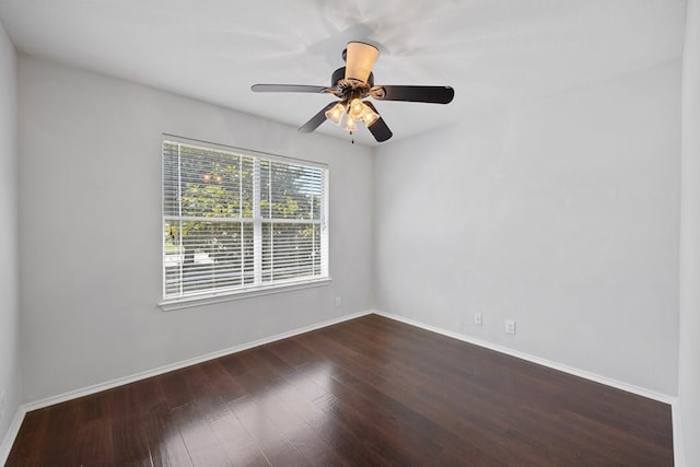 spare room featuring dark wood-type flooring and ceiling fan