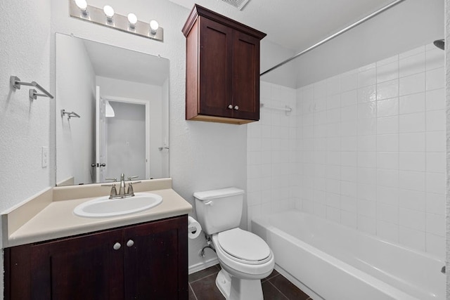 full bathroom featuring tile patterned flooring, vanity, toilet, and tiled shower / bath