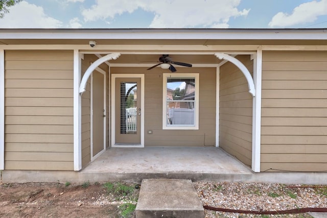 entrance to property with a patio and ceiling fan