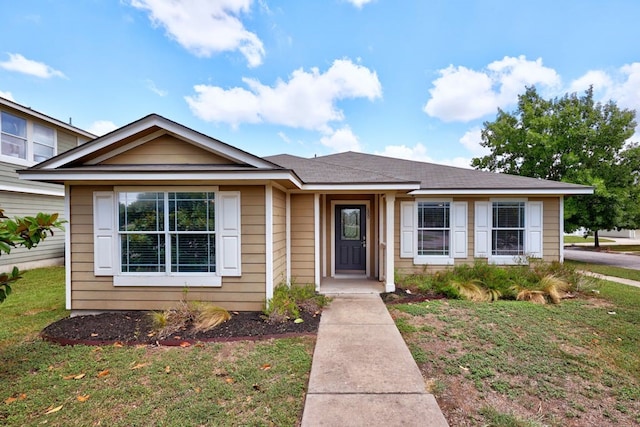 bungalow-style home with a front lawn