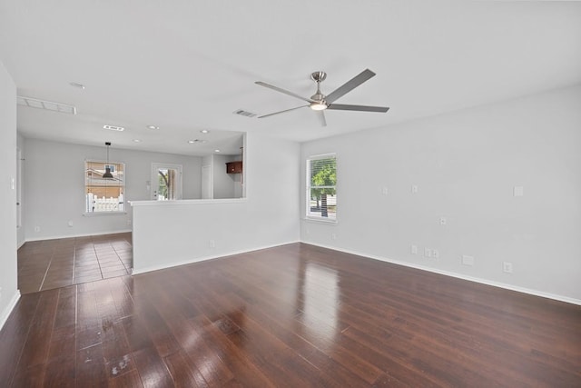 unfurnished living room with ceiling fan and dark hardwood / wood-style floors