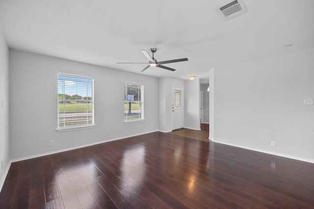 spare room featuring dark hardwood / wood-style flooring and ceiling fan