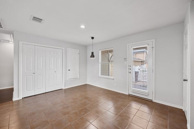 unfurnished bedroom with tile patterned floors and a closet