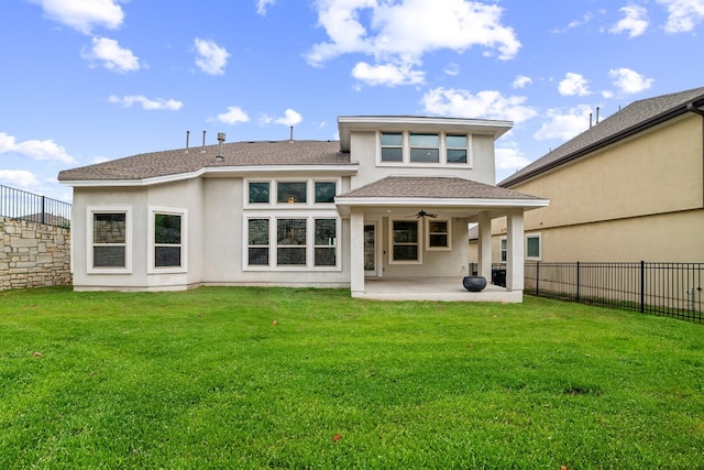 back of property featuring ceiling fan, a lawn, and a patio area