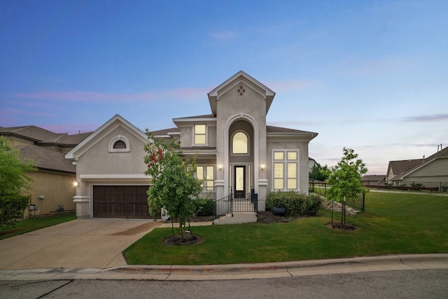 view of front of house with a garage and a lawn