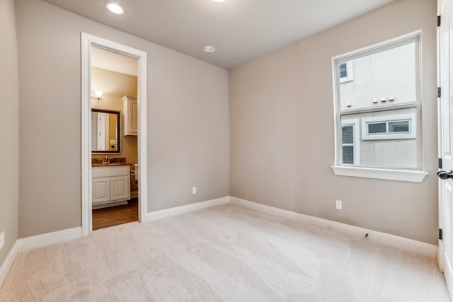 carpeted empty room with a wealth of natural light