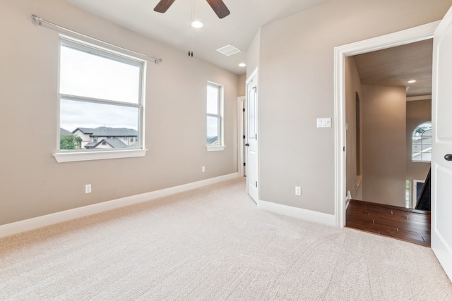 unfurnished bedroom with light colored carpet and ceiling fan