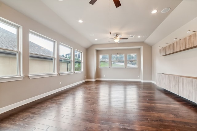 unfurnished room with ceiling fan, vaulted ceiling, and dark hardwood / wood-style flooring