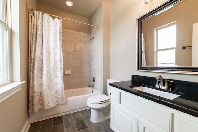 full bathroom featuring toilet, shower / tub combo, vanity, and a wealth of natural light