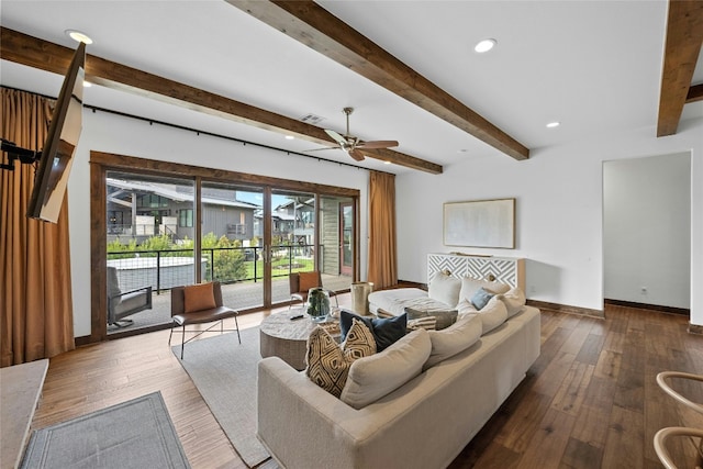 living room featuring beamed ceiling, ceiling fan, and dark hardwood / wood-style floors