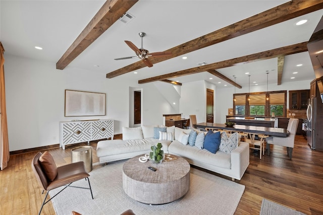 living room featuring ceiling fan, dark hardwood / wood-style floors, and beam ceiling