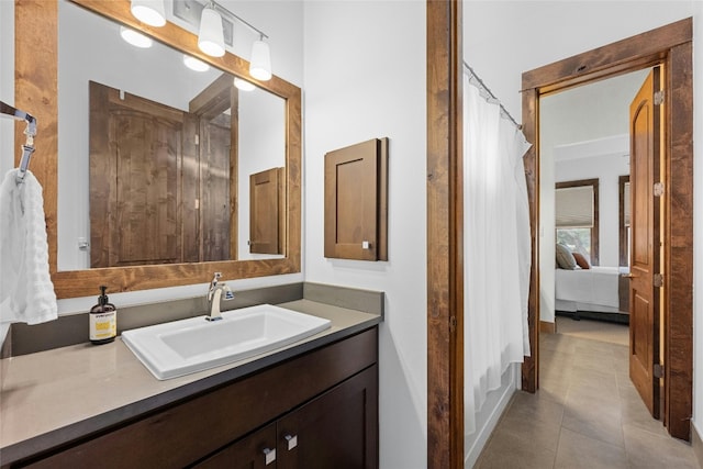 bathroom with vanity, walk in shower, and tile patterned flooring