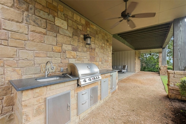 view of patio / terrace featuring area for grilling, an outdoor kitchen, ceiling fan, and sink