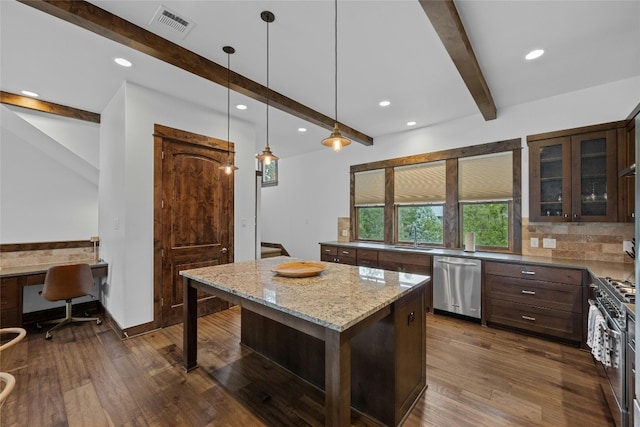 kitchen featuring dark hardwood / wood-style flooring, a kitchen island, stainless steel appliances, and light stone countertops