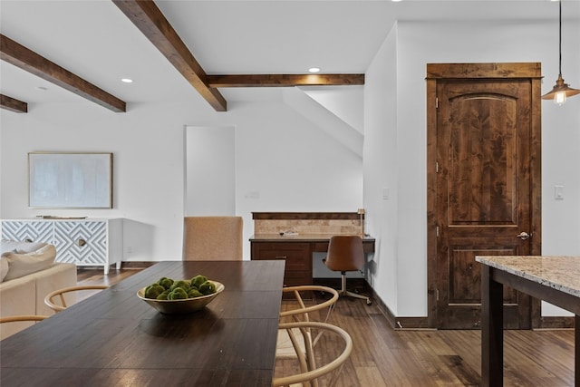 dining area with built in desk, dark hardwood / wood-style floors, and beamed ceiling