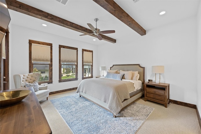 bedroom with light colored carpet, beam ceiling, and ceiling fan