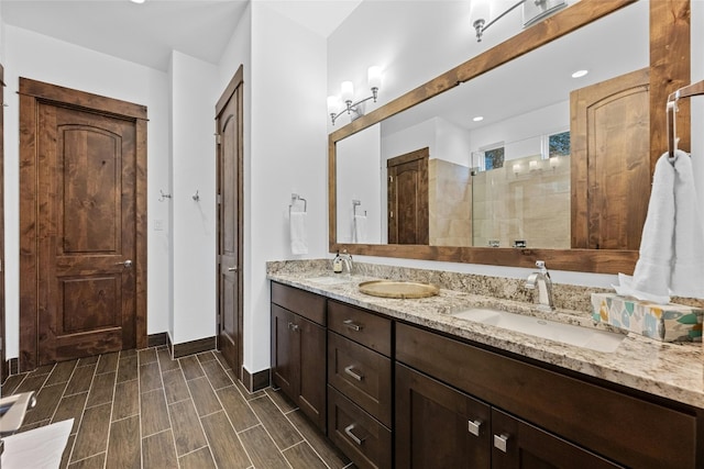 bathroom featuring tiled shower, hardwood / wood-style flooring, and vanity