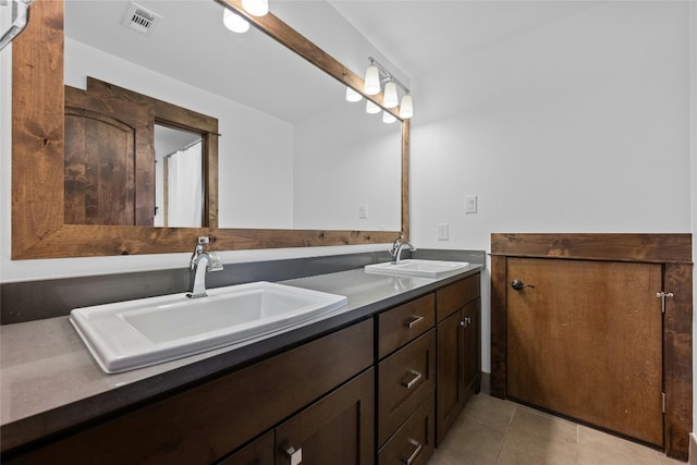 bathroom with tile patterned floors and vanity