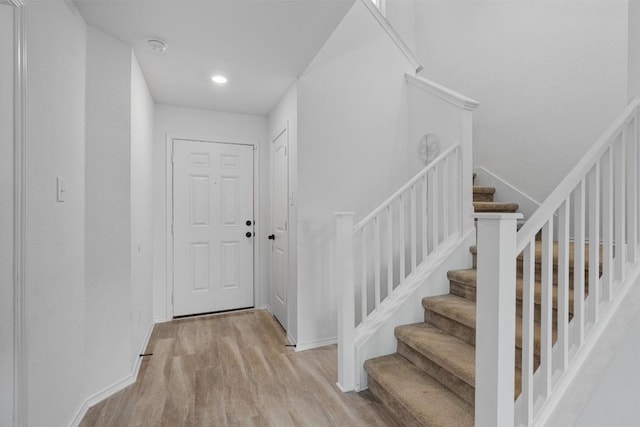 staircase with hardwood / wood-style floors