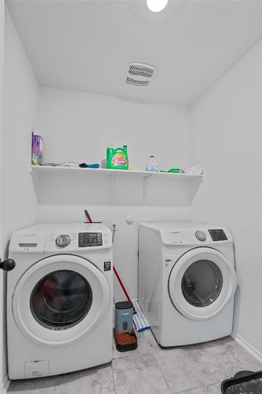 washroom featuring washer and dryer