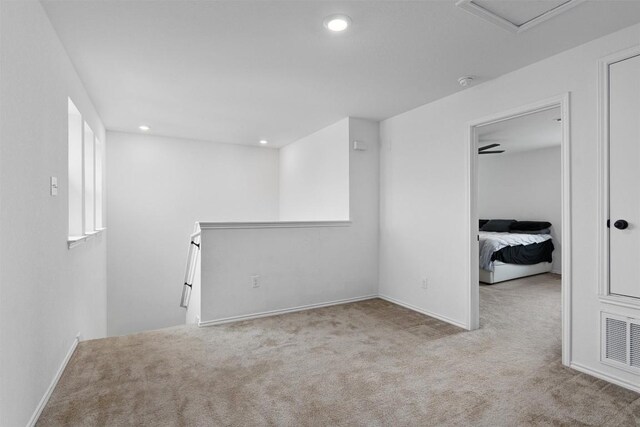 spare room featuring light carpet